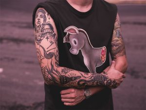 half ass graphic t-shirt on a tattooed dude